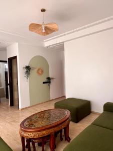 a living room with a coffee table and a ceiling at Central Urban Terrace in Rabat