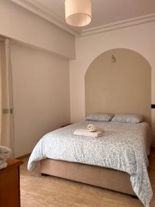 a bedroom with a bed with a white comforter at Central Urban Terrace in Rabat