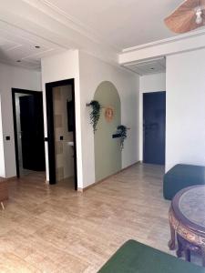 a living room with white walls and a blue couch at Central Urban Terrace in Rabat