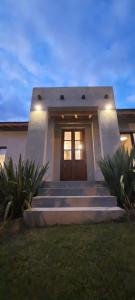 a house with stairs leading to a door at Casa de Campo Roca - Exclusivo para Parejas in Villa Cura Brochero