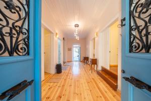 a hallway with a blue door and a dining room at Eleofilos Old Town in Mytilene