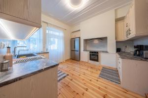 a large kitchen with wooden floors and a counter top at Eleofilos Old Town in Mytilene