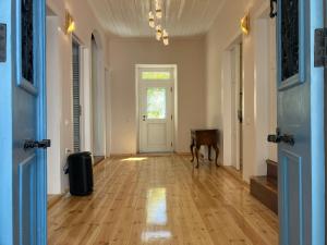 an empty hallway with a dog standing in front of a door at Eleofilos Old Town in Mytilene