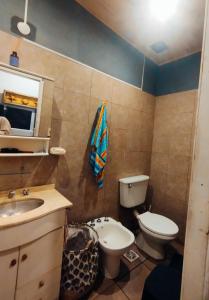 a bathroom with a toilet and a sink at Martin House in Chascomús