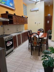 a kitchen with a table and a stove top oven at Alojamiento El Cardenal in Iquitos