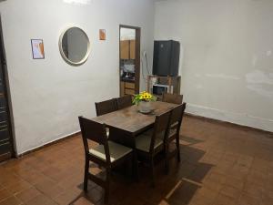 a dining room table with a vase of flowers on it at Casa 3 Quartos Espaço Luxemburgo in Anápolis