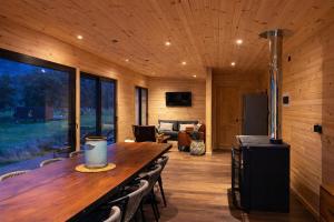a room with a long wooden table and chairs at Puerta austral in Puelo