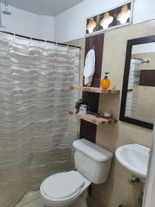 a bathroom with a toilet and a sink at Finca Cercanías Marinilla - Casa Campestre in Marinilla +53 photos