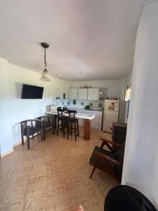 a kitchen and dining room with a table and chairs at Finca Cercanías Marinilla - Casa Campestre in Marinilla