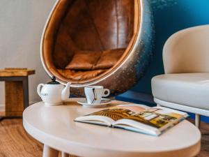 a round table with a book and a mirror at ibis Styles Ancenis Centre in Ancenis