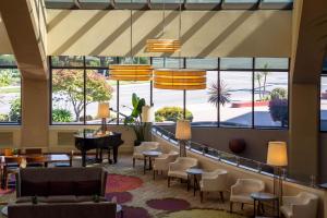 a lobby with large windows and a grand piano at Walnut Creek Marriott in Walnut Creek