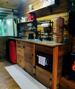 a kitchen with a wooden counter top in a room at Diamond Cabin in the Forest | Hot Tub | AC | Fire Pit in Gonçalves