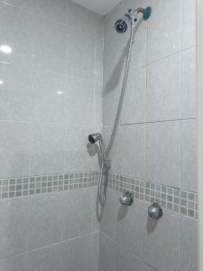 a shower in a bathroom with a shower head at Hotel Torreon in Mexico City +8 photos