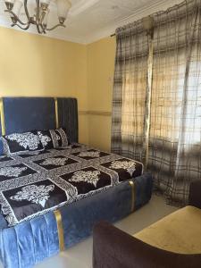 a bedroom with a blue bed with a blanket on it at CEO Da Gracia Hotel, Irewon, Ijebu Ode in Ijebu Ode