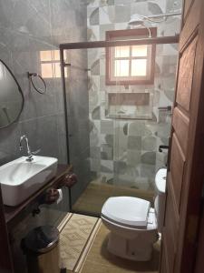 a bathroom with a toilet and a sink and a shower at Pousada Vó Iris - Tiradentes Mg in Tiradentes +119 photos