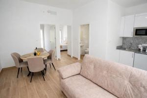 a living room with a couch and a table at Apartamentos Turísticos El Cholo in Fisterra