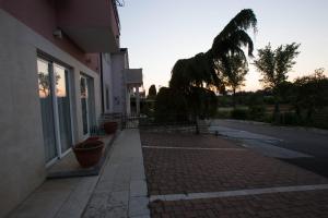 a brick sidewalk next to a building with a sunset at Villa Lugano in Rovinj