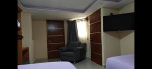 a room with a chair and a bed and a window at HOTEL PUEBLO BONITO in Zacatlán +19 photos