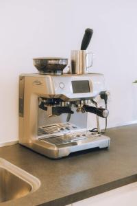 a coffee maker sitting on top of a counter at High end 3 BR Spacious Villa for 6 guests in Norðskáli