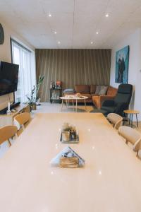 a living room with a couch and a table at High end 3 BR Spacious Villa for 6 guests in Norðskáli