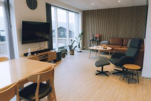 a living room with a couch and a table at High end 3 BR Spacious Villa for 6 guests in Norðskáli +29 photos