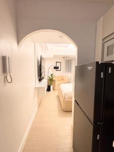 a room with a refrigerator and a bedroom at Cloud Haven Suite at Azure North Pampanga in San Fernando +18 photos