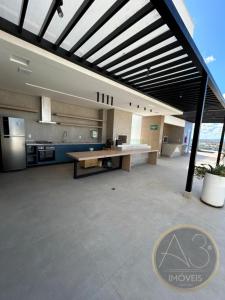 a large kitchen with a wooden table in a room at City House 204 in Barreiras
