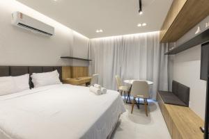 a bedroom with a bed and a table with chairs at City House 204 in Barreiras