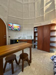 a dining room with a wooden table and two stools at Animal Glamping in Pomona