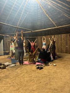 a group of people doing yoga in a tent at Animal Glamping in Pomona