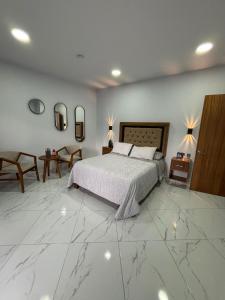 a bedroom with a bed and a marble floor at Hotel Casa FRALO in Atotonilco el Alto +24 photos