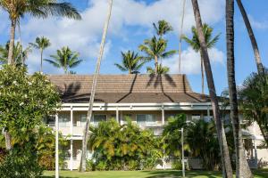 an exterior view of a building with palm trees at Plantation Hale Suites in Kapaa +75 photos