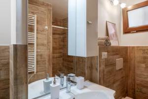 a bathroom with a sink and a shower with a mirror at ApartVilla Trieste in Trieste +55 photos