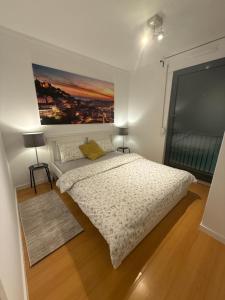 a bedroom with a bed and a painting on the wall at sony cottage in Lisbon