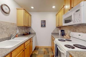 a kitchen with a white stove and a sink at Payette Pines Hideaway in McCall