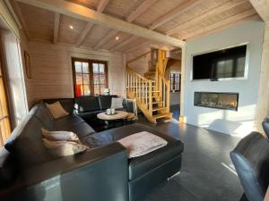 a living room with a couch and a fireplace at Forest Villa, Rural Twente in Den Ham
