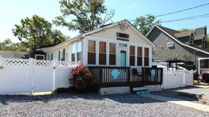 a small white house with a white fence at Shell Shack in Villas