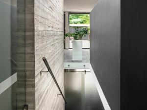 a hallway of a house with a plant on the wall at Wellness Villa with Private Spa in Oosterhout +29 photos