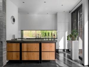 a kitchen with a counter with a sink in it at Wellness Villa with Private Spa in Oosterhout