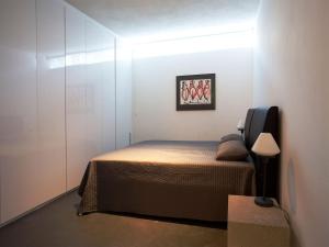 a bedroom with a bed in a white room at Wellness Villa with Private Spa in Oosterhout