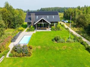 an aerial view of a house with a yard at Villa with Heated Pool, Sauna in Aalten