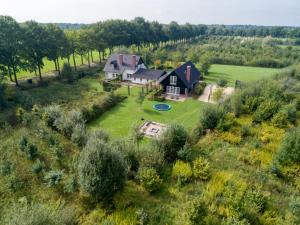 an aerial view of a large house with a yard at Achterhoek Estate with Private Pool in Aalten