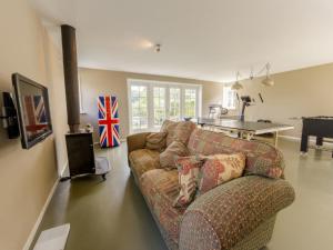 a living room with a couch and a table at Achterhoek Estate with Private Pool in Aalten