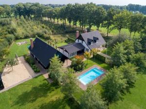 an aerial view of a house with a swimming pool at Achterhoek Estate with Private Pool in Aalten