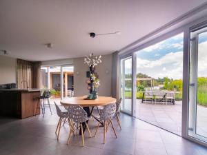 a kitchen and dining room with a table and chairs at Water Villa, Sauna & Beach in Sibculo