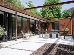 an outdoor patio with a table and chairs at Wellness Villa with Private Sauna in Oosterhout