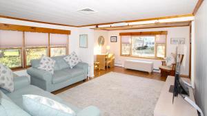 a living room with a couch and a tv at Summer Breeze in Cape May Point