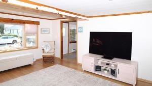 a living room with a large flat screen tv at Summer Breeze in Cape May Point