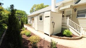 a house with a white shed on the side of it at Summer Breeze in Cape May Point