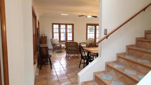 a living room with a staircase and a table and chairs at Pet Friendly And Steps To The Bay in Villas